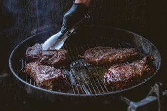 Person frying the steaks
