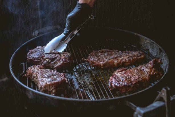 Person frying the steaks
