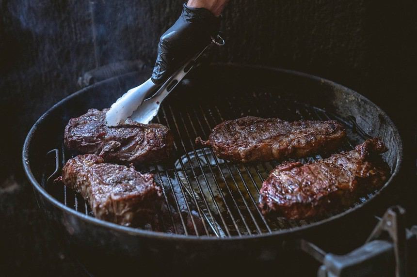 Person frying the steaks