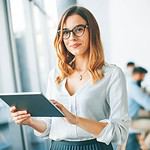 elegant businesswoman standing office with digital tablet1