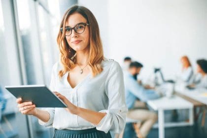 elegant businesswoman standing office with digital tablet1