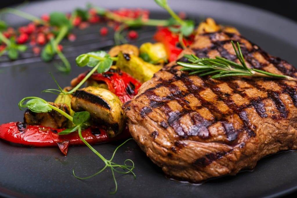 Grilled Meat and Vegetables with Herb Garnish