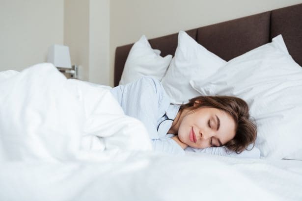 cheerful young lady dressed pajama sleeping bed