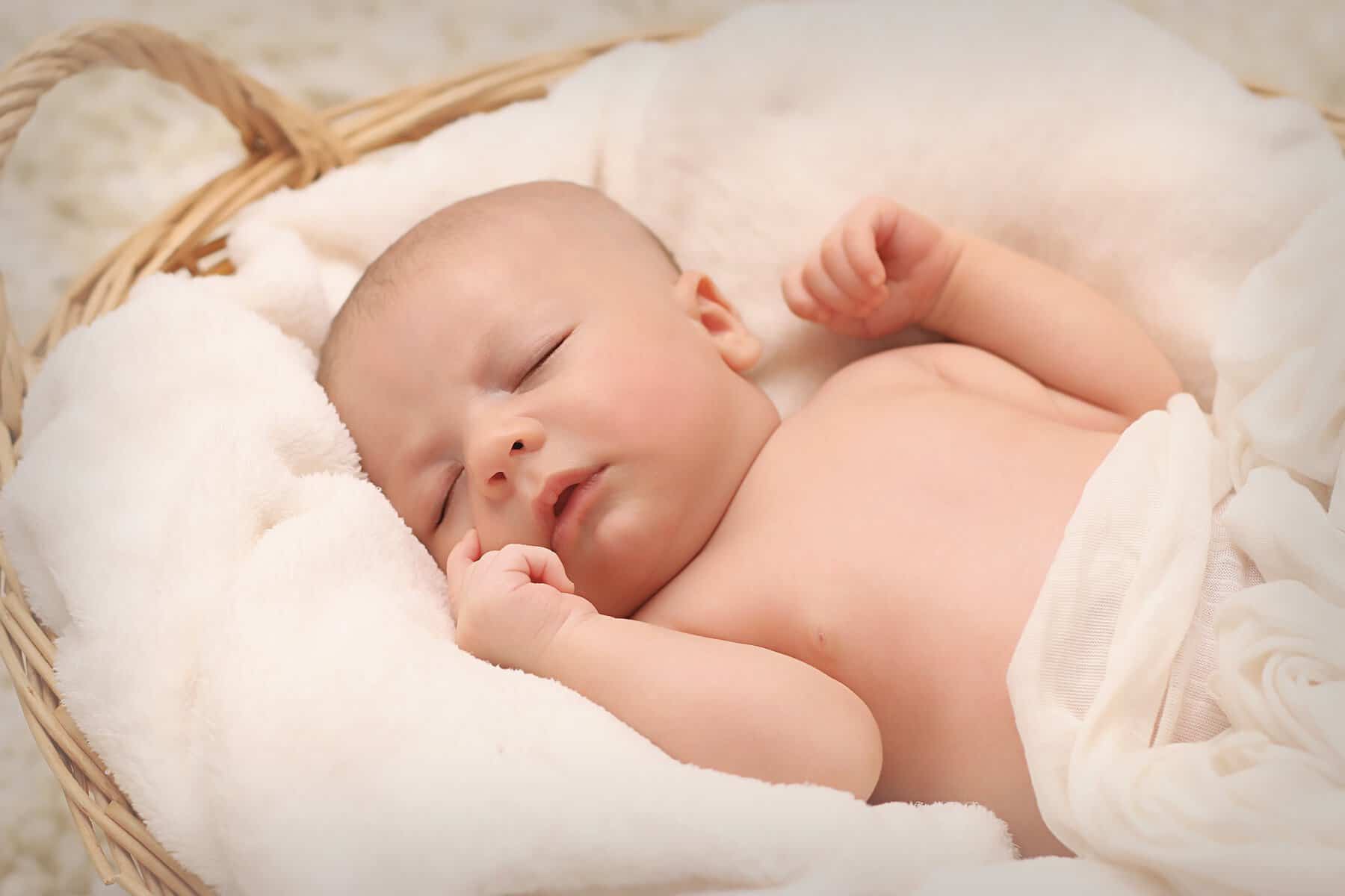 newborn sleeping on sleep sack